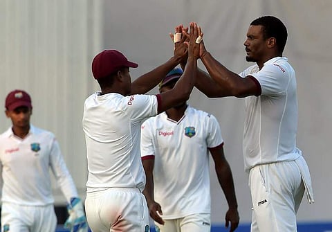 West Indies' bowler Shannon Gabriel (R) celebrates with teammates after the dismissal of Pakistani batsman Sarfraz Ahmed unseen on the first day of the third and final Test between Pakistan. | AFP