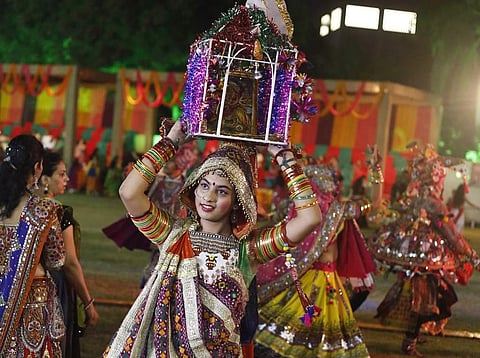 A girl in traditional attire performs Garba for Navratri, which started on October 1st. (Photo | AP)
