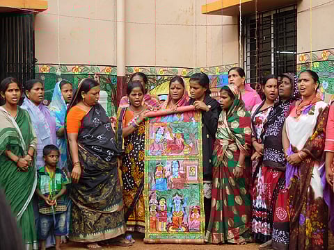 Muslim Patua Chitrakars singing Hindu mythological song of Rasleela while unfolding a 'potchitro' in Naya village on Saturday. | (Aishik Chanda | Express Photo Service)