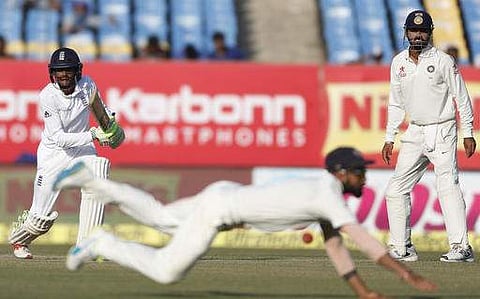 England's batsman Haseeb Hameed, left, bats as Indian cricket captain Virat Kohli tries to stop a ball on the fourth day. (Photo | AP)