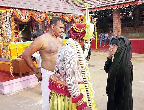 A Muslim woman talks about her grievances to ‘Ali Bhoota’ during the annual jatra; (below) The deity Padangara Bhagavati