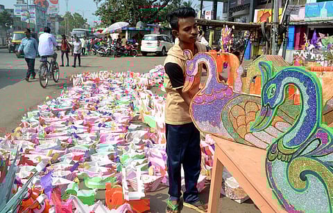 A youth selling thermocol boats on the eve of Kartika Purnima in Cuttack on Sunday | Express