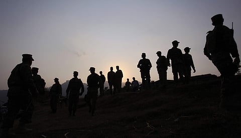 Pakistan army soldiers gather at a forward area post on the Line of Control (LOC), that divides Kashmir between Pakistan and India. | AP