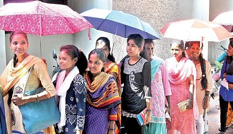 Being a holiday, girl students line up to exchange banned H500 and H1,000 notes from a bank near Collector Office Junction in Visakhapatnam on Sunday | Express
