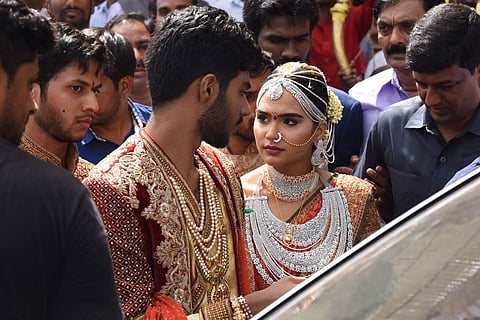 After the ceremony, the bride and the groom make way to their car to drive away to their new life. (EPS | Nagaraja Gadekal)