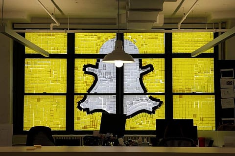 An image of the Snapchat logo created with Post-it notes is seen in the windows of Havas Worldwide at 200 Hudson Street in lower Manhattan, New York, U.S. | Reuters