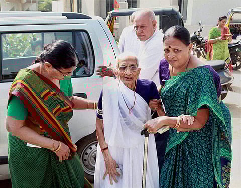 PM Narendra Modi’s mother Heeraben Modi being brought to a bank to exchange scrapped notes in Gandhinagar on Tuesday | PTI