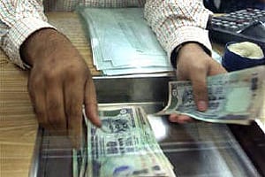 A forex dealer counts rupee notes. (File photo | Reuters)