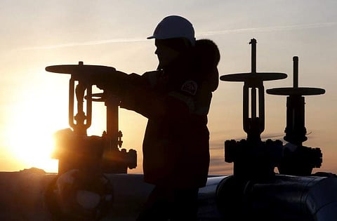 A worker checks the valve of an oil pipe at the Lukoil company owned Imilorskoye oil field outside the West Siberian city of Kogalym, Russia, January 25, 2016. (Photo | Reuters)