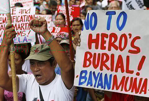 Protesters shout slogans as they await the ruling of the Philippine Supreme Court on whether to allow or not the burial of the late Philippine dictator Ferdinand Marcos at the Heroes' Cemetery. | AP