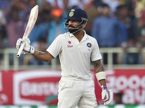 Virat Kohli raises his bat to celebrate scoring fifty runs on the third day of India's second cricket test match against England. (Photo | AP)