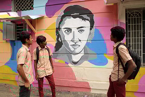 Schools boys look at Colorful Graffiti depicting the many years of Kollywood cinema at Saidapet station,Chennai. (Sunish P Surendran |EPS)