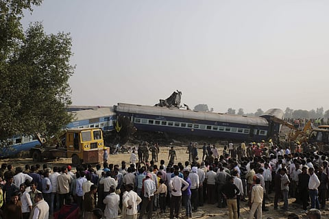 People gather after 14 coaches of an overnight passenger train rolled off the track near Pukhrayan village Kanpur Dehat district, Uttar Pradesh. | AP