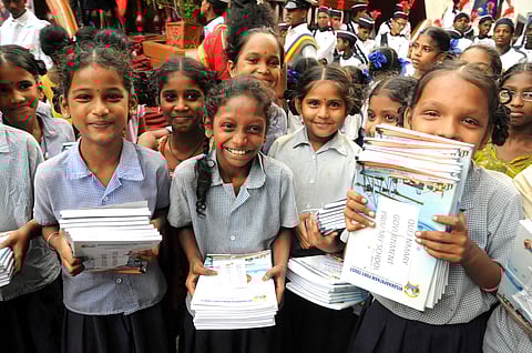 Girl students of a government school after receving free books at a CSR programme. (File photo | EPS)