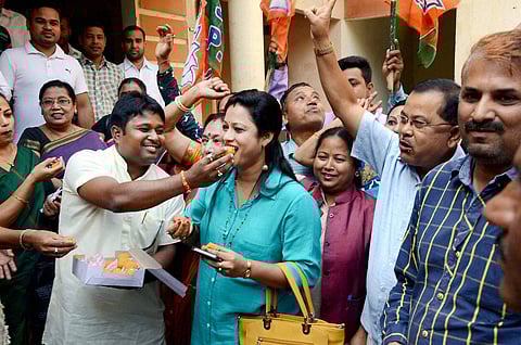 Bharatiya Janata Party BJP workers celebrate the win of party candidates from Lakhimpur Lok Sabha seat and Boithalangsu assembly seat in Guwahati . (PTI)