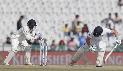 India's Parthiv Patel tries to stump England's Jos Buttler unsuccessfully on the first day of their third cricket test match against India in Mohali. | AP