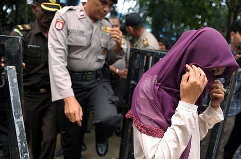 An Indonesian woman walks prior to receiving 100 lashes of the cane for violating Sharia. (Photo | AFP)