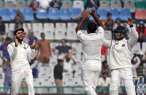 Indian test cricket team captain, Virat Kohli, left, Mohammed Shami, center, and Karun Nair celebrate the dismissal of England's Adil Rashid on the fourth day of their third cricket test match. | AP