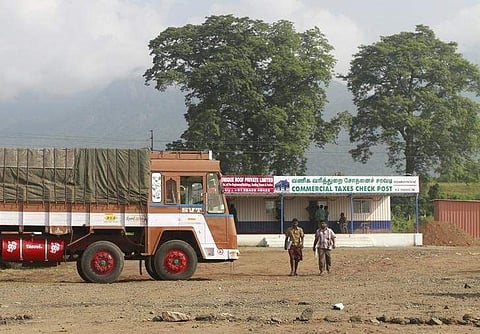 Truck drivers walk out of a Commercial Taxes Department check post after getting clearance to cross a checkpoint in Tamil Nadu (Photo | Reuters)