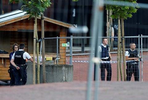 Belgian police officers stand guard outside the main police station after a machete-wielding man injured two female police officers before being shot in Charleroi, Belgium, August 6, 2016.  | Reuters