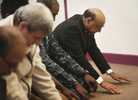 Khizr Khan (right most), whose son Army Capt. Humayun Khan was killed in Iraq and who criticized Donald Trump's statements on Muslims, joins in prayer at a mosque in Virginia. (File Photo | AP)