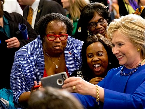 Democratic presidential candidate Hillary Clinton takes pictures with supporters. (File photo | AP)