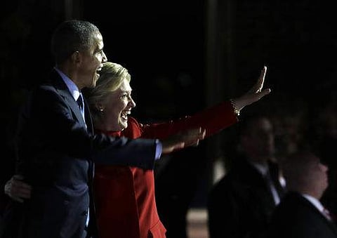Democratic presidential candidate Hillary Clinton takes the stage and waves with President Barack Obama during a campaign event at Independence Mall on Monday. | AP