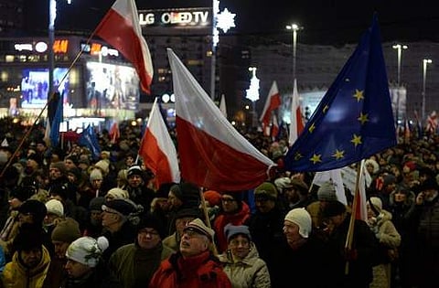 Anti-government demonstrators attend a rally in Warsaw on the 35th anniversary of the martial law on December 13. (Photo | AFP)