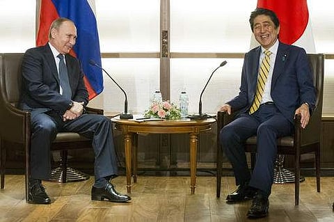 Japanese Prime Minister Shinzo Abe, right, and Russian President Vladimir Putin smile during their meeting at a hot springs resort in Nagato, Japan. (Photo | AP)