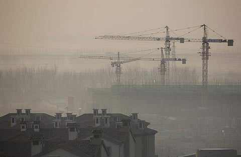 Apartment blocks are pictured next to a construction site on a hazy day in Wuqing district of Tianjin, China, December 10, 2016. (Photo | Reuters)