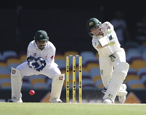 Pakistan's Yasir Shah plays a shot as Australia's wicket keeper Matthew Wade, left, looks on during play on the final day of the first cricket test between Australia and Pakistan. (Photo | AP)