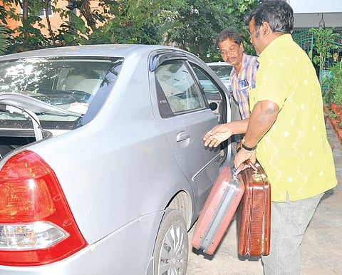 Officials of the Income Tax department with the cash, jewellery and documents seized from  Shekar Reddy’s house in Katpadi. (File | EPS)