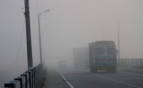 Vehicle move in dense fog on Jammu-Srinagar highway in Jammu. | PTI
