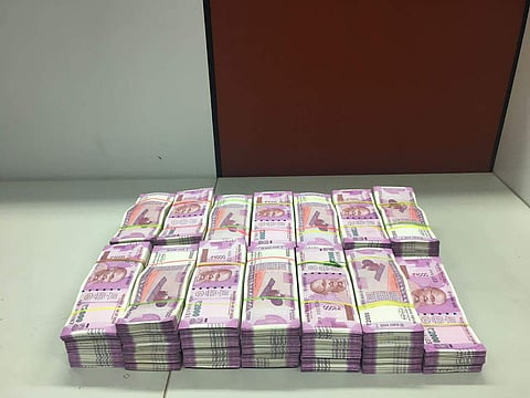 Rs 1.34 crore in denomination of Rs 2,000 currencies from five persons near Chennai airport. | EPS