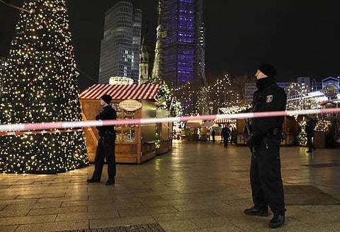 Police stand guard after a truck ran into the crowded Christmas market in Berlin. (File photo |AP)