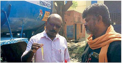 A Food Safety Department official inspecting water at a Metro water filling station | Express