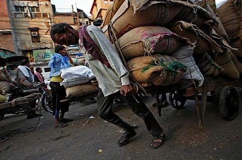 A labourer pulls a cart loaded with sacks of spices at a wholesale spice and chemical market in the old quarters of Delhi, India, December 19, 2016. Picture taken December 19, 2016. REUTERS