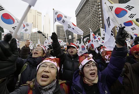 Supporters of impeached South Korean President Park Geun-hye shout slogans during a rally opposing her impeachment in Seoul, South Korea, Saturday, Dec. 24, 2016. | AP