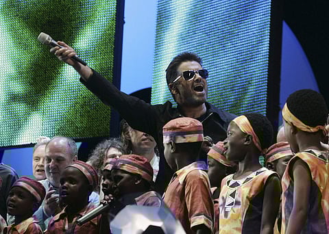 In this Saturday, July 2, 2005 file photo, British singer George Michael accompanied by other musicians and children from Africa wave to the crowds goodbye at the finale the Live 8 concert in Hyde Park, London. | AP
