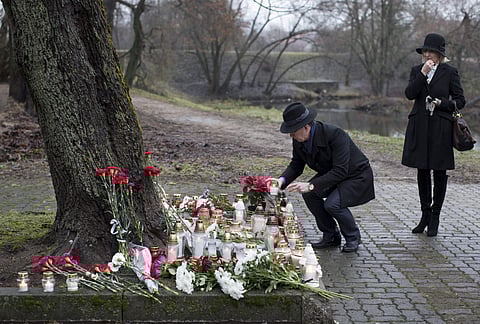 People put flowers in memory of victims of the crashed plane in front of the Russia's Embassy in Vilnius, Lithunia, Monday, Dec. 26, 2016. | AP