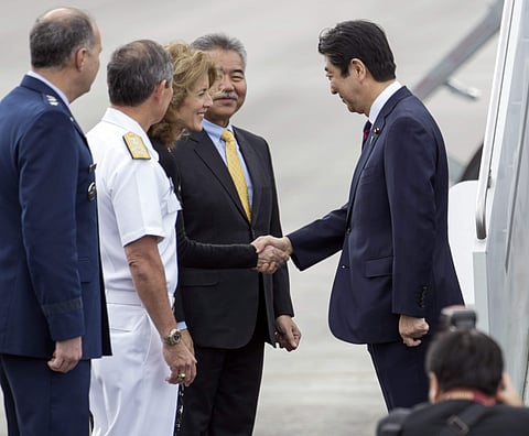 Caroline Kennedy, U.S. Ambassador to Japan, third from left, greets Japan's Prime Minister Shinzo Abe at Joint Base Pearl Harbor Hickam. (Photo | AP)