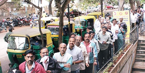 People standing in front of a Syndicate Bank branch in Malleswaram in Bengaluru on Friday I S Manjunath