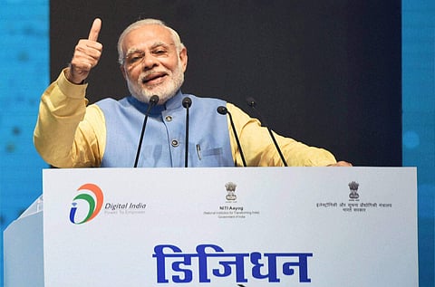 Prime Minister Narendra Modi addressing at the launch of a new mobile app 'Bhim' to encourage e-transactions at Talkatora Stadium in New Delhi on Friday. | PTI