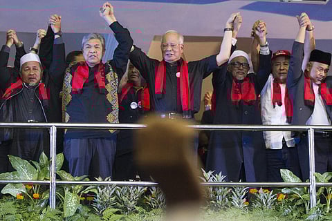 Malaysian Prime Minister Najib Razak, center, holds hands with other leaders during a protest against the persecution of Rohingya Muslims in Myanmar. | AP
