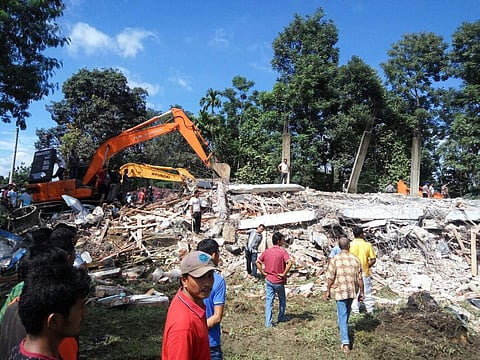 Rescuers use heavy machine to search for survivors under the rubble of a collapsed building after an earthquake in Pidie Jaya, Aceh province, Indonesia, Wednesday, Dec. 7, 2016. | AP