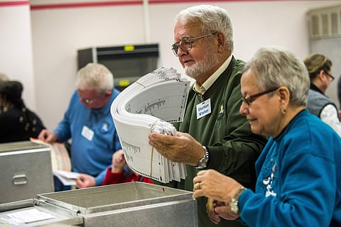 Election workers recount votes on Flint ballots, as they begin the process of a statewide recount on Wednesday, Dec. 7, 2016 at Genesee County Administration Building in Flint, Mich. | AP
