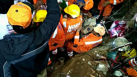 Rescue personnel looking through the rubble on the site of the seven storey building that collapsed  in Nanakramguda on Thursday.( R Satish Babu | EPS)