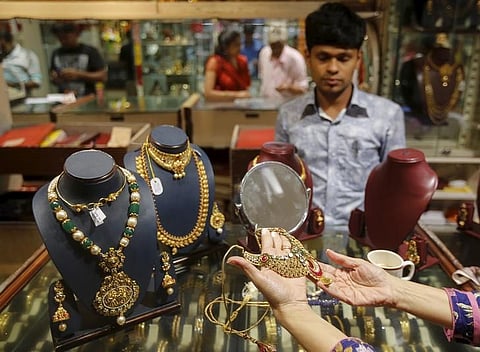 A customer tries a gold necklace at a jewellery showroom in Mumbai, India, November 9, 2015 | Reuters