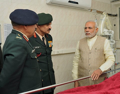 Prime Minister Narendra Modi with Army chief Gen Dalbir Singh and head of the medical team in the ward at a ward of Army s Research Referral Hospital where Lance Naik Hanumanthappa who is critical is being treated in New Delhi on Tuesday | PTI