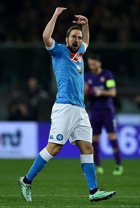 Napoli's Argentinian forward Gonzalo Higuain celebrates after scoring a goal during the Italian Serie A football match between Fiorentina and Napoli on February 29, 2016, at the Artemio Franchi stadium in Florence. | AFP